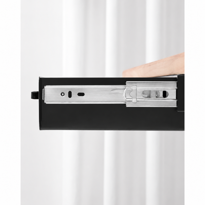 Close-up of the black drawer side and metal ball-bearing slide rail beneath a wood desktop.